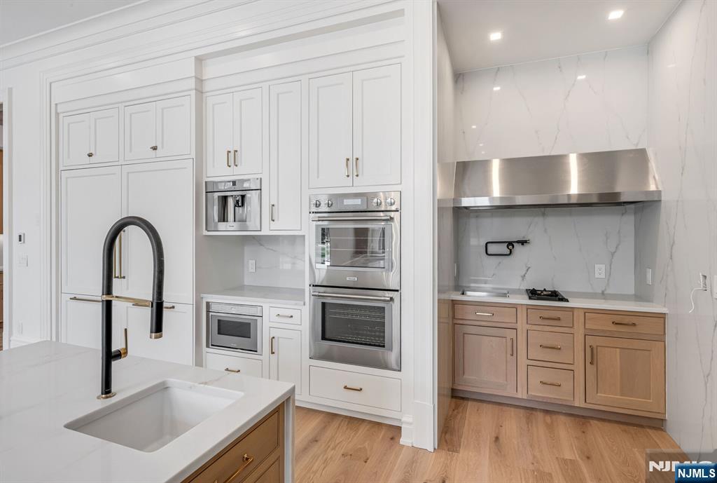 19 Rio Vista Drive Alpine, NJ 07620 - Photo 15 of 49 a kitchen with stainless steel appliances granite countertop a sink stove and cabinets