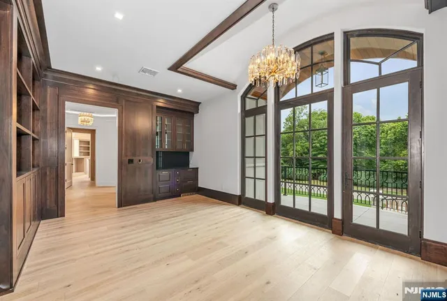 a spacious bedroom with a large bed and a large window