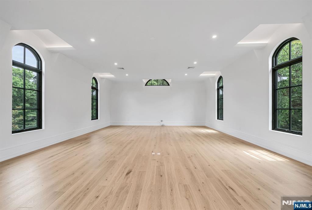 19 Rio Vista Drive Alpine, NJ 07620 - Photo 34 of 49 an empty room with wooden floor and windows