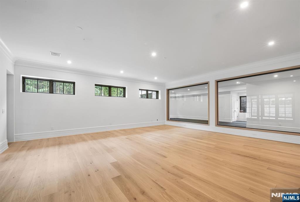 19 Rio Vista Drive Alpine, NJ 07620 - Photo 38 of 49 a view of an empty room with wooden floor and a window