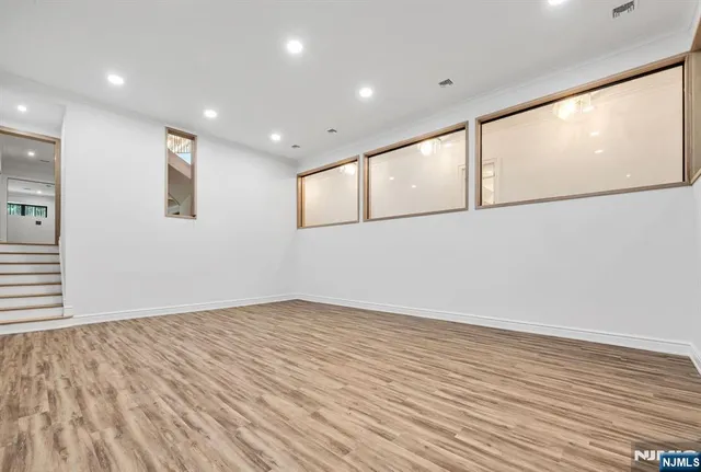 a view of a room with large windows and a chandelier