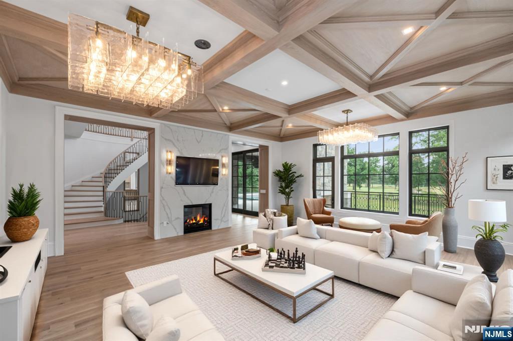 19 Rio Vista Drive Alpine, NJ 07620 - Photo 10 of 49 a living room with furniture a fireplace and a large window