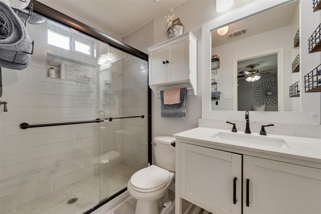 149 Cattlemans Creek Road Newark, TX 76071 - Photo 18 of 39 Primary bathroom with ceramic tile floors and large shower with sliding glass doors at 149 Cattlemans Creek Rd in the Chisholm Springs neighborhood in Newark, TX 76071