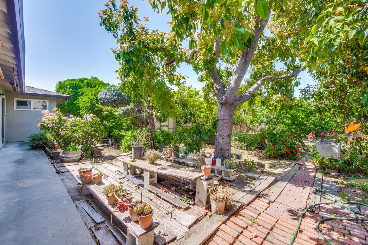 2738 Cramer Circle San Jose, CA 95111 - Photo 23 of 63 a view of backyard with a table and chairs under an umbrella