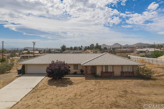 16030 Mandan Road Apple Valley, CA 92307 - Photo 1 of 1 a front view of a house with a yard