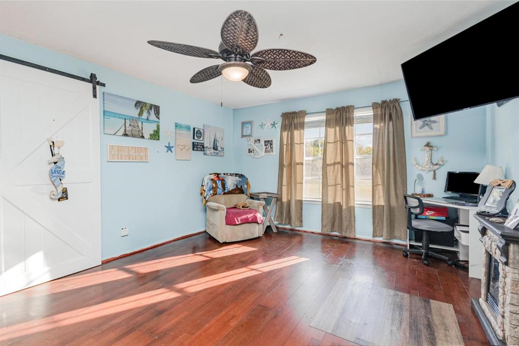 18888 Highway 274 Kemp, TX 75143 - Photo 14 of 30 a bedroom with furniture a flat screen tv and a window