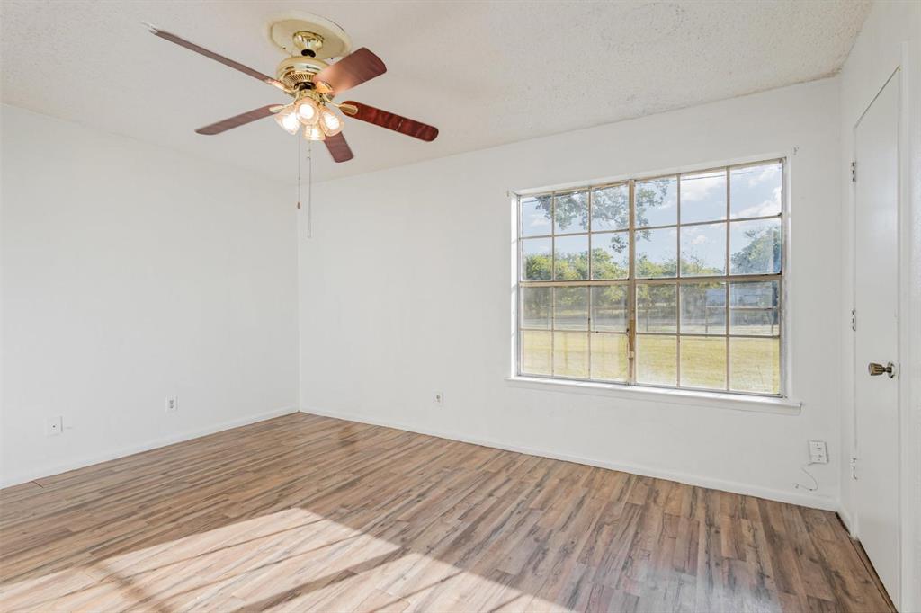 18888 Highway 274 Kemp, TX 75143 - Photo 18 of 30 wooden floor in an empty room with a window