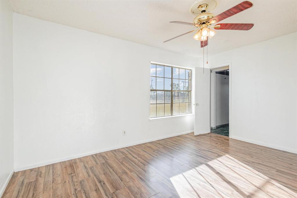18888 Highway 274 Kemp, TX 75143 - Photo 19 of 30 an empty room with wooden floor fan and windows