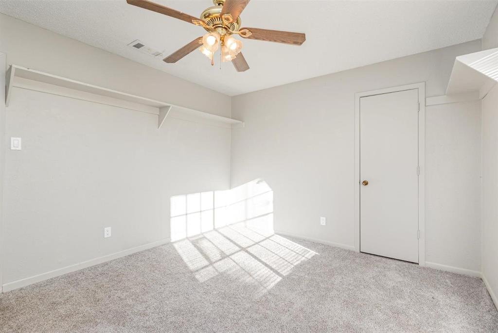 18888 Highway 274 Kemp, TX 75143 - Photo 21 of 30 an empty room with chandelier fan and windows