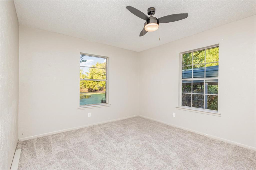 18888 Highway 274 Kemp, TX 75143 - Photo 22 of 30 an empty room with windows and a ceiling fan