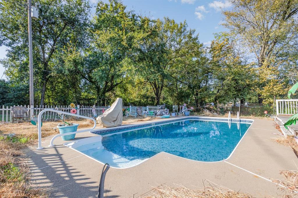 18888 Highway 274 Kemp, TX 75143 - Photo 28 of 30 a view of a swimming pool with a sitting space and garden