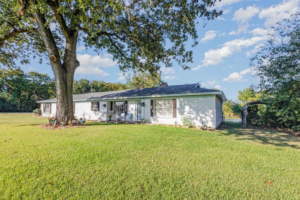18888 Highway 274 Kemp, TX 75143 - Photo 4 of 30 a front view of a house with a garden and trees