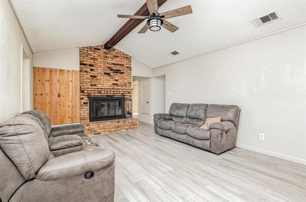 18888 Highway 274 Kemp, TX 75143 - Photo 6 of 30 a living room with furniture a fireplace and a flat screen tv