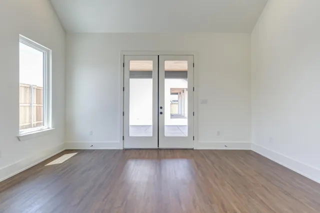 a view of a hallway with wooden floor and closet