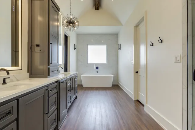 a view of a room with wooden floor and a ceiling fan