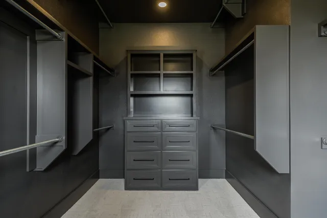 a kitchen with granite countertop a refrigerator and a stove top oven