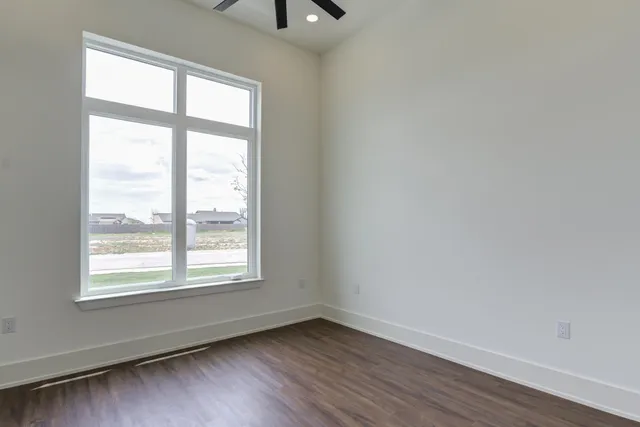 a kitchen with granite countertop stainless steel appliances a stove and wooden floor