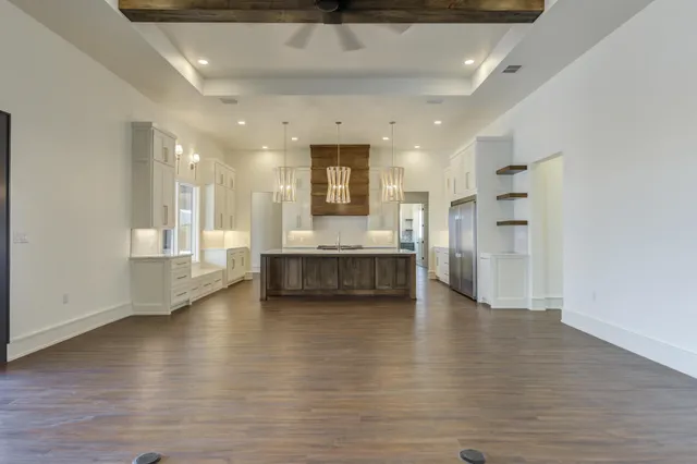 a kitchen with kitchen island a sink stainless steel appliances and cabinets