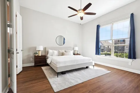a bedroom with a large bed and a large window