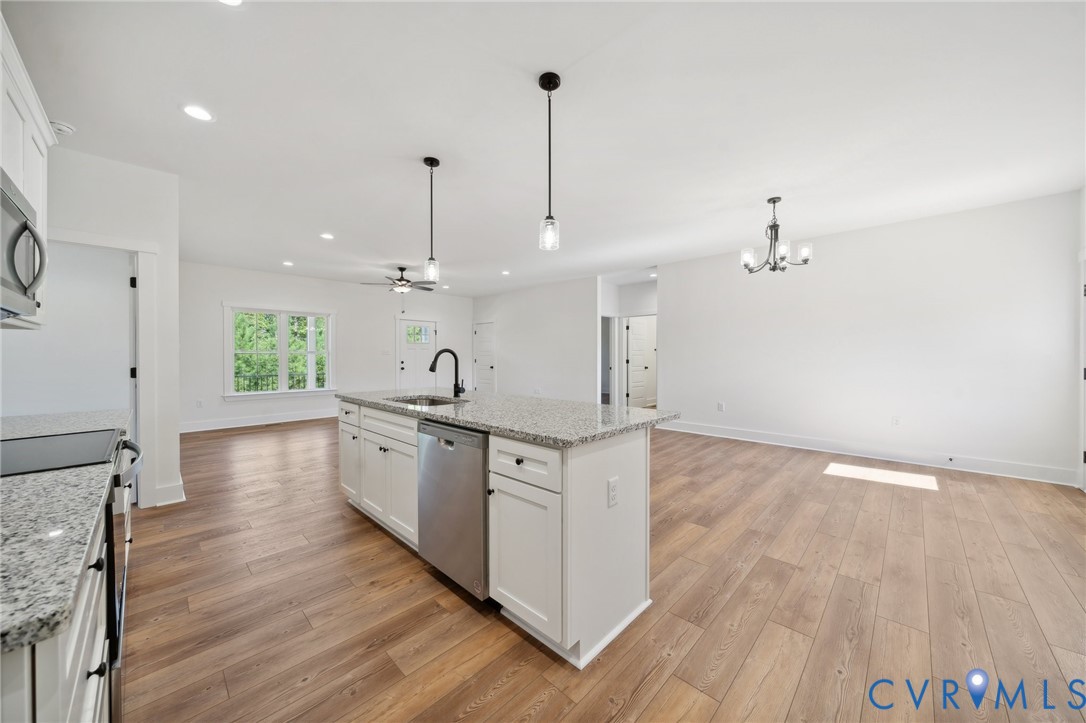 75 Oak Hill Road Cumberland, VA 23040 - Photo 11 of 34 a large kitchen with stainless steel appliances a large counter top a sink a refrigerator and a window