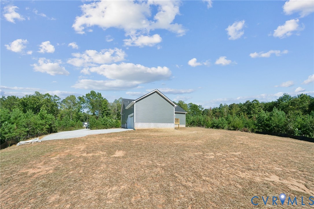 75 Oak Hill Road Cumberland, VA 23040 - Photo 30 of 34 a view of an house with backyard and a garden