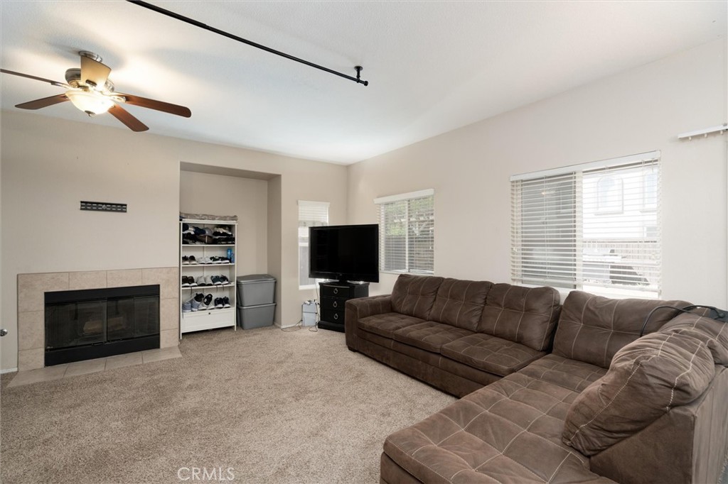 37867 Shady Maple Road Murrieta, CA 92563 - Photo 13 of 68 a living room with furniture a fireplace and a flat screen tv