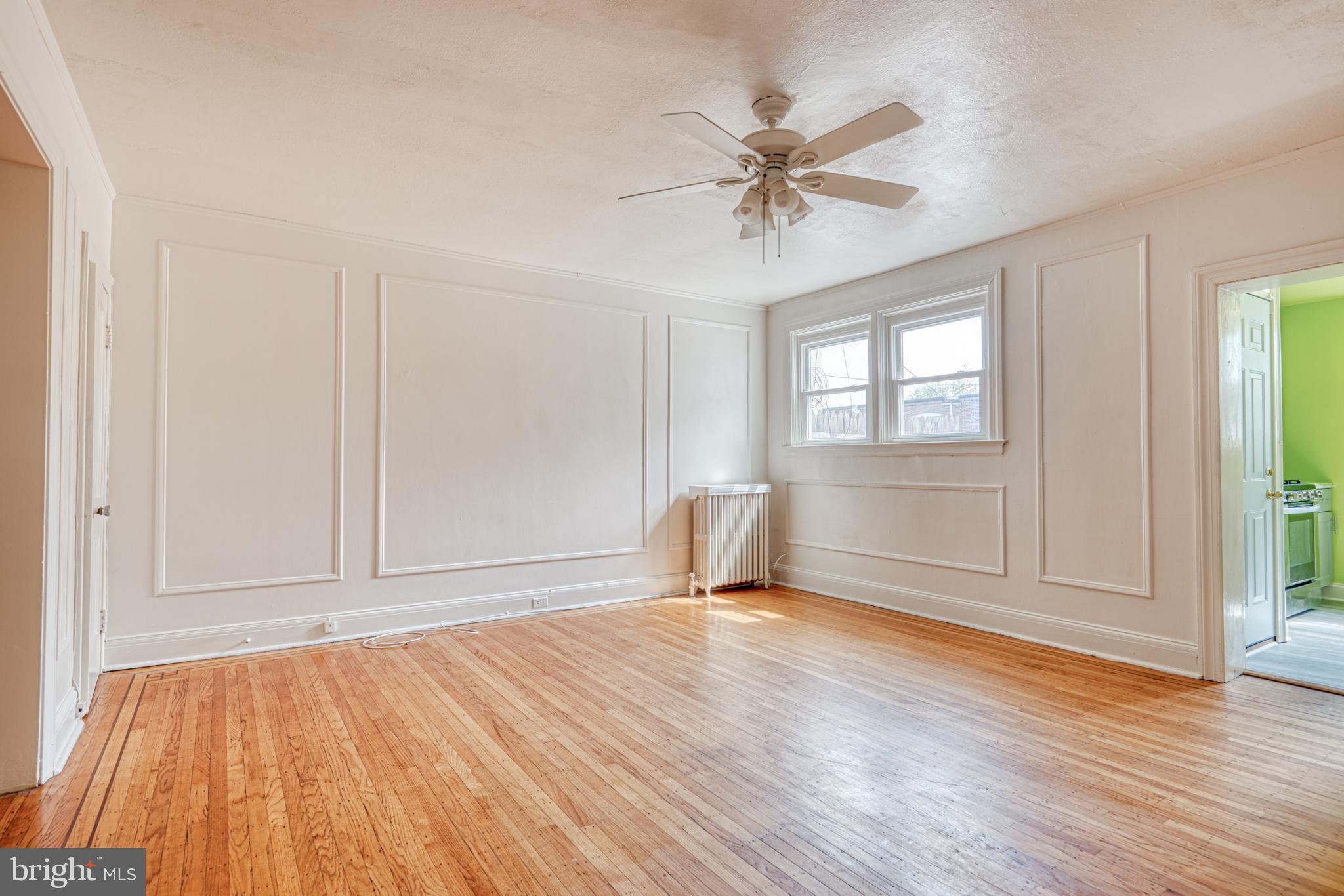 3621 Elkader Road Baltimore, MD 21218 - Photo 11 of 32 a view of empty room with wooden floor and fan