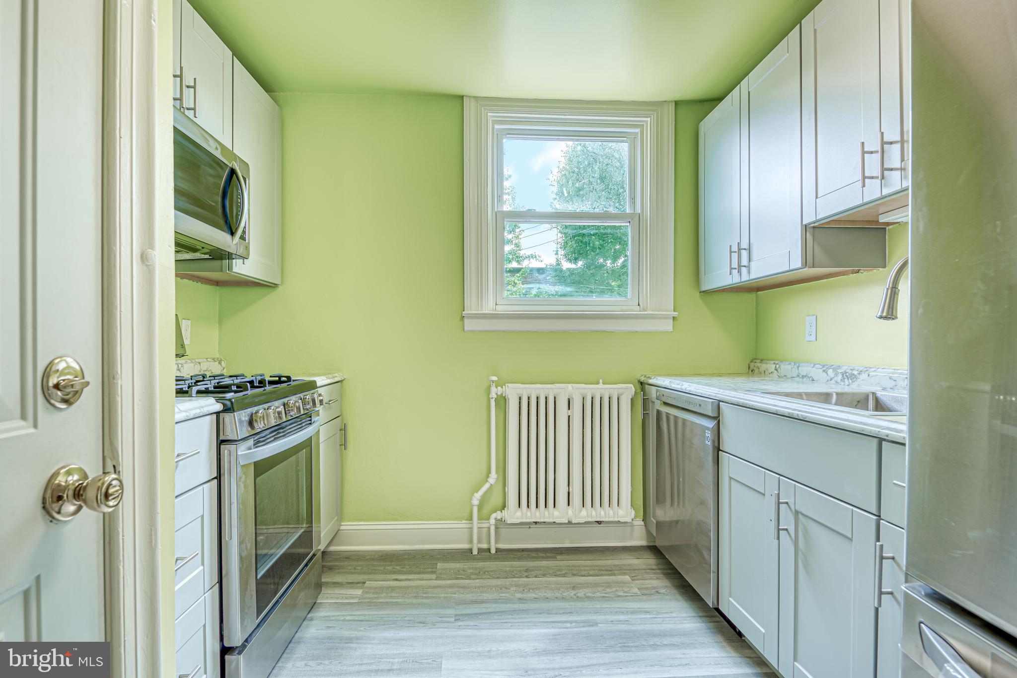 3621 Elkader Road Baltimore, MD 21218 - Photo 14 of 32 a kitchen with a sink and a stove top oven