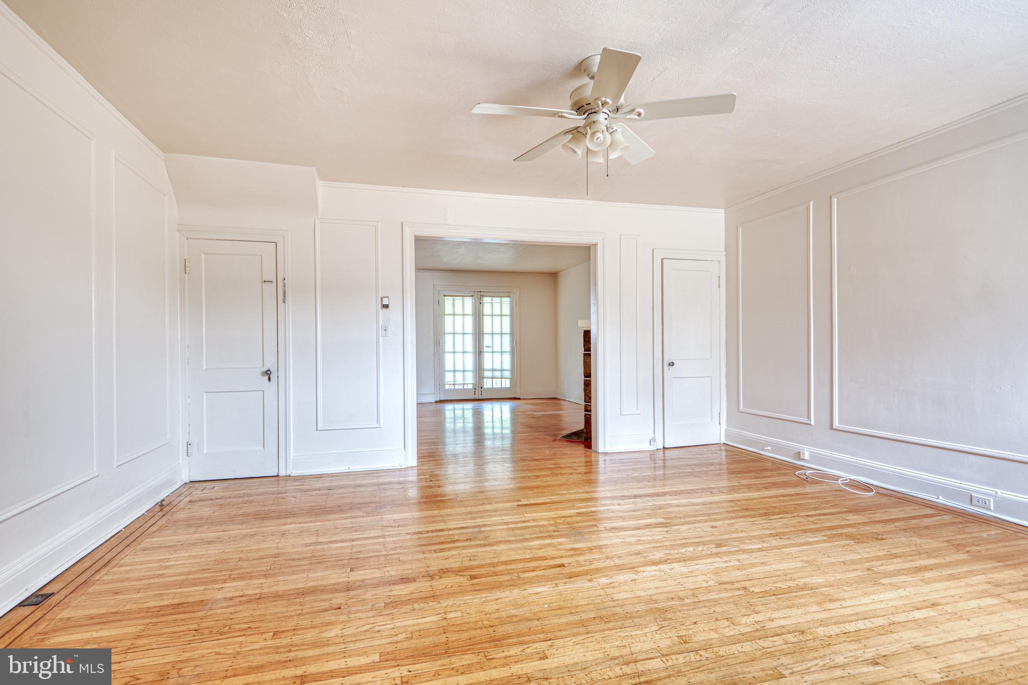 3621 Elkader Road Baltimore, MD 21218 - Photo 15 of 32 a view of empty room with wooden floor and fan