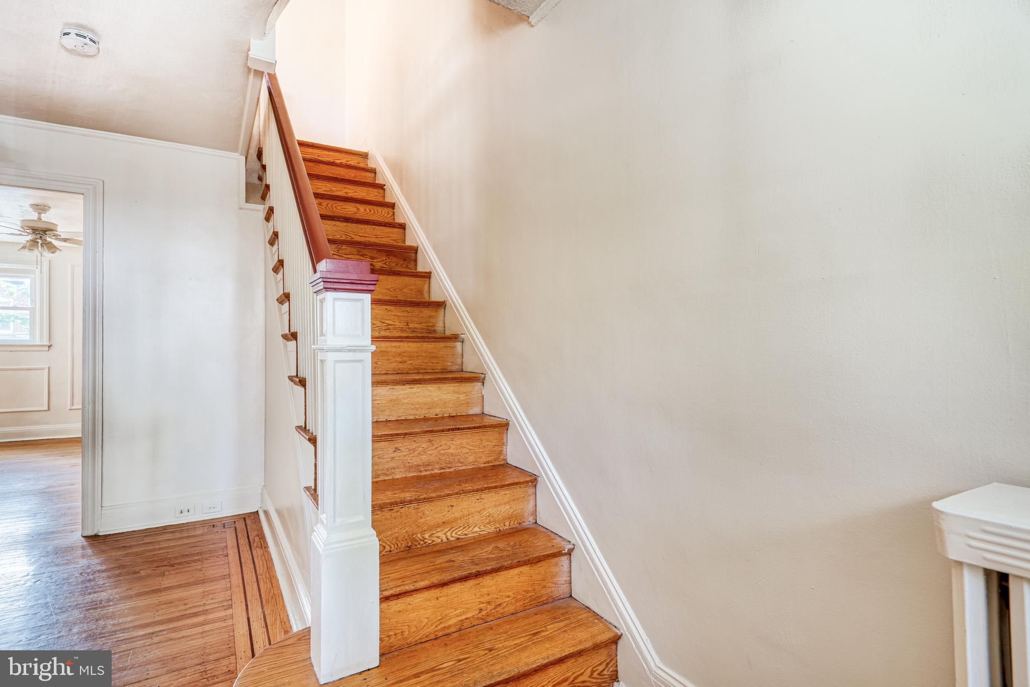 3621 Elkader Road Baltimore, MD 21218 - Photo 16 of 32 a view of staircase with wooden floor and white walls