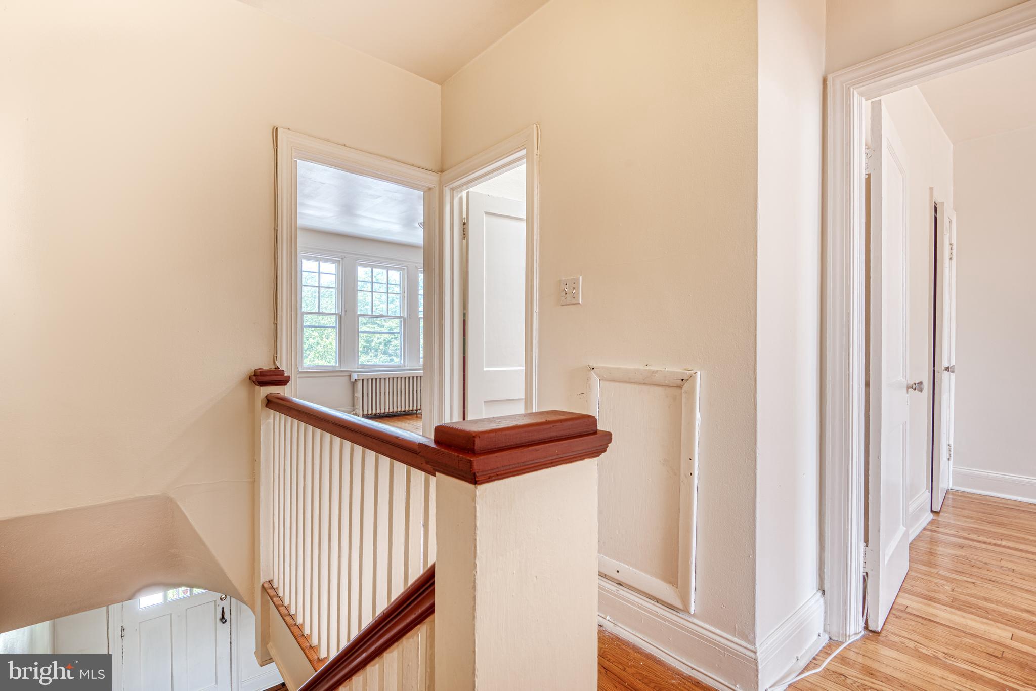 3621 Elkader Road Baltimore, MD 21218 - Photo 17 of 32 a view of a hallway with windows and stairs