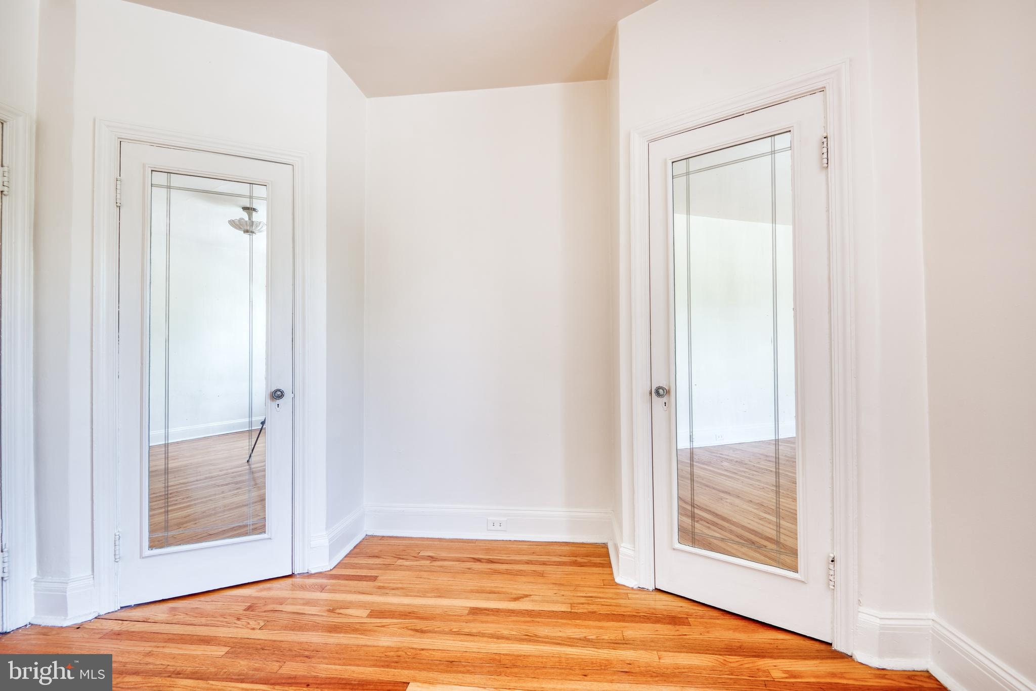 3621 Elkader Road Baltimore, MD 21218 - Photo 20 of 32 a view of a room that has a bed and wooden floor