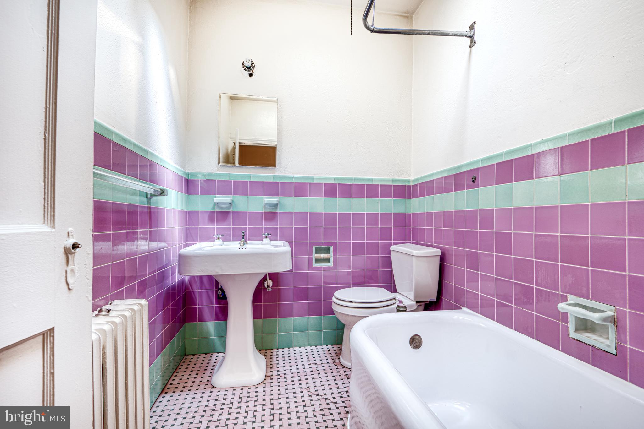 3621 Elkader Road Baltimore, MD 21218 - Photo 21 of 32 a bathroom with a sink a toilet and shower curtain
