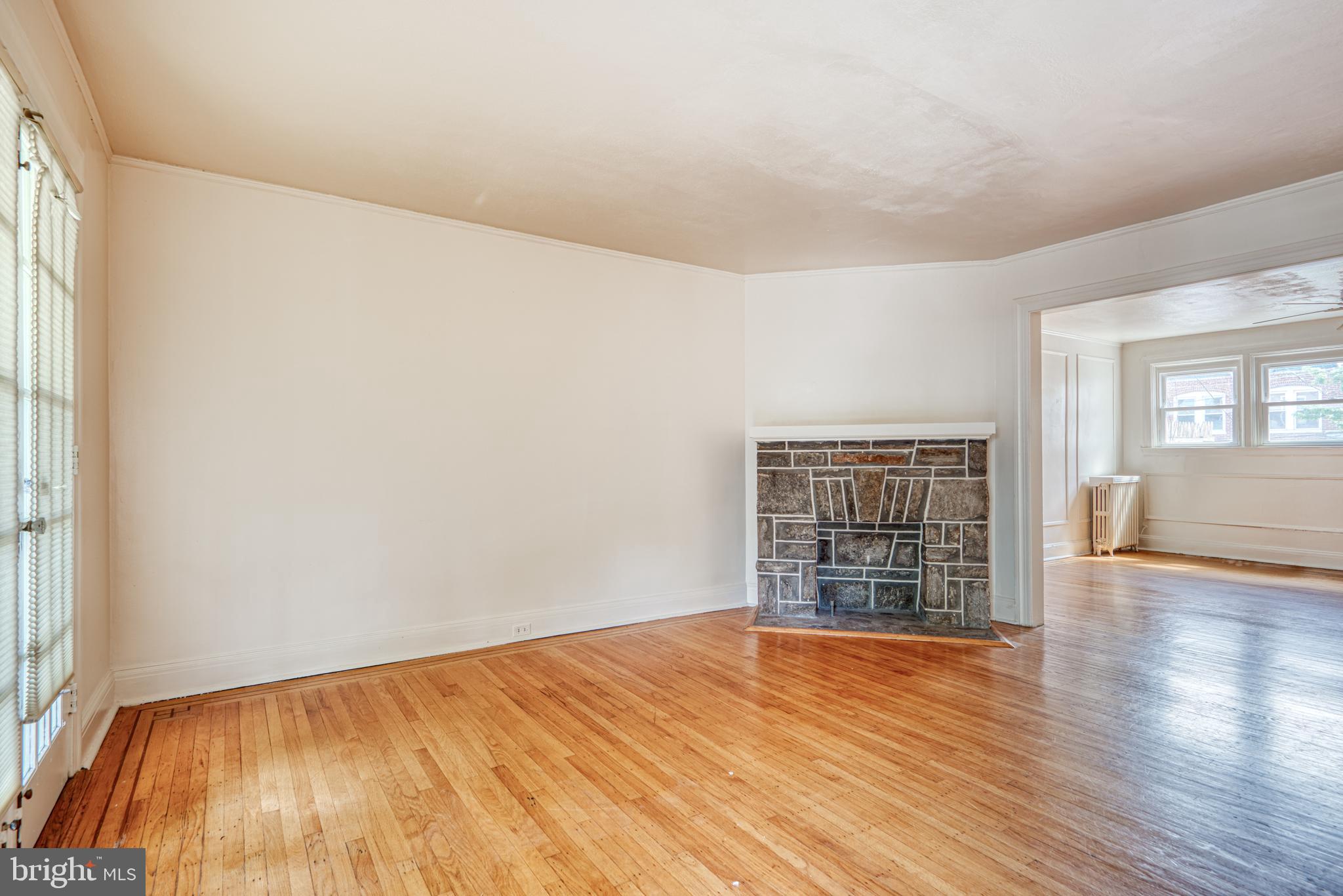 3621 Elkader Road Baltimore, MD 21218 - Photo 7 of 32 wooden floor in an empty room with a window