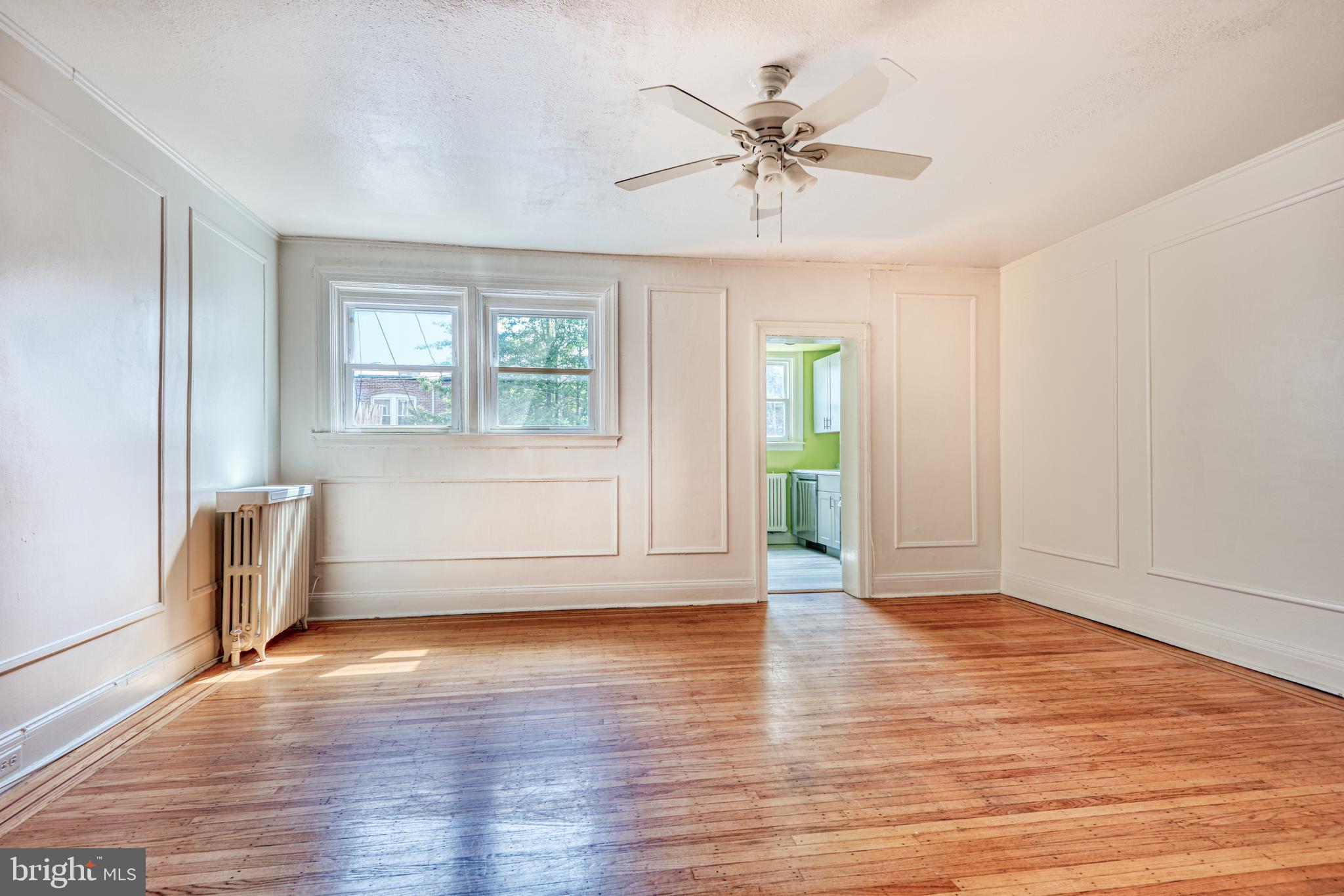 3621 Elkader Road Baltimore, MD 21218 - Photo 10 of 32 an empty room with wooden floor and windows