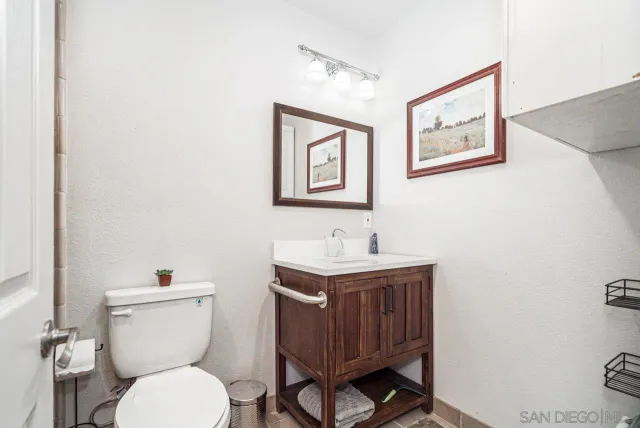 a bathroom with a toilet a sink and mirror