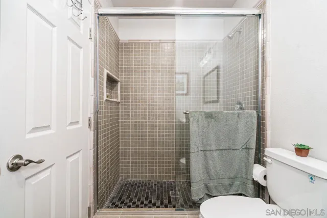 a bathroom with a toilet and shower