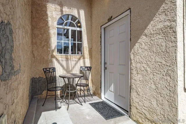 a view of a hallway with furniture and entryway