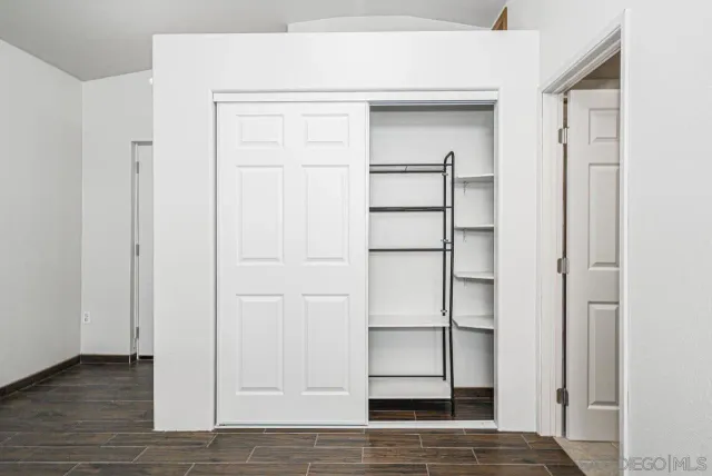 a view of walk in closet with empty racks