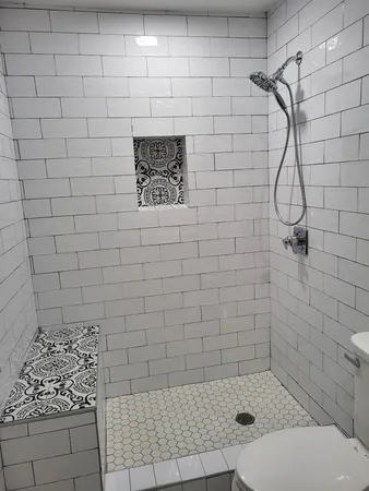 a bathroom with a toilet and a shower