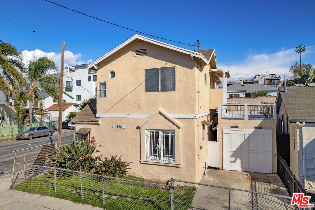 1650 South Rimpau Boulevard Los Angeles, CA 90019 - Photo 1 of 52 a view of a house with a yard
