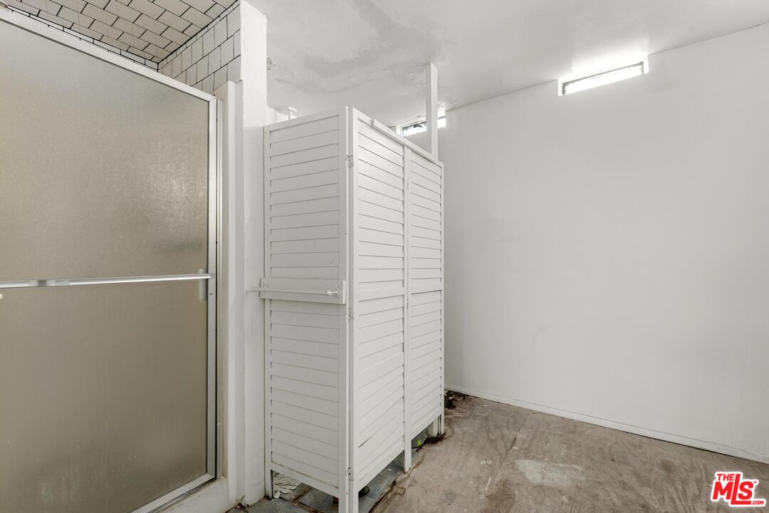 1650 South Rimpau Boulevard Los Angeles, CA 90019 - Photo 25 of 52 a bathroom with a shower and a glass door