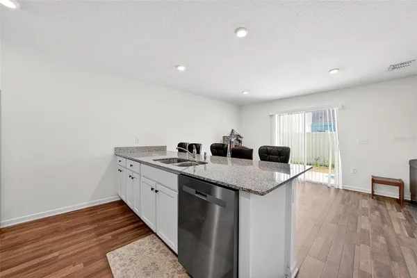 a view of a kitchen counter space and wooden floor
