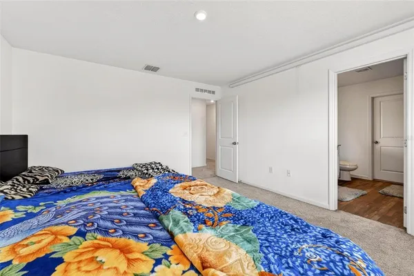 a bedroom with a bed and dresser