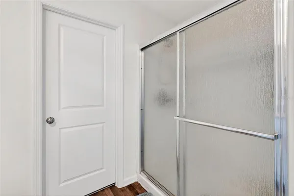 a bathroom with a glass shower door