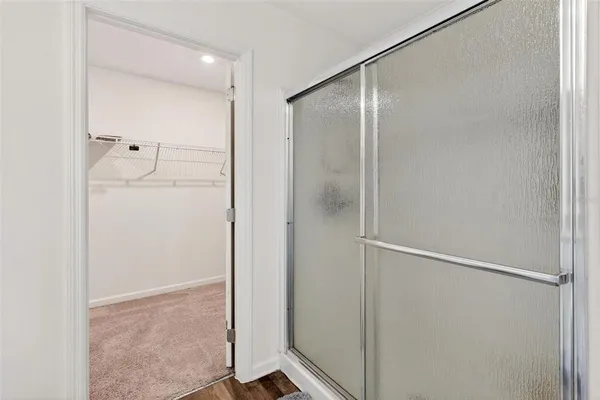 a bathroom with a glass shower door
