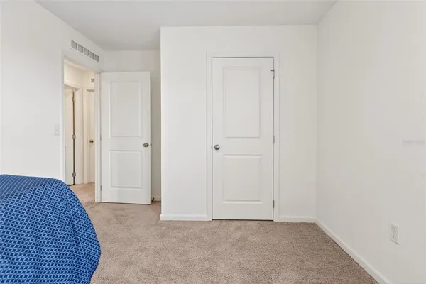 a en suite bathroom with a granite countertop sink and a mirror