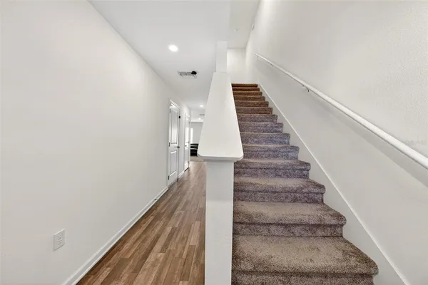 an entryway of a house and an empty room