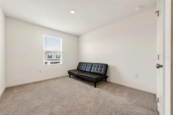 a view of a room with wooden floor and a window