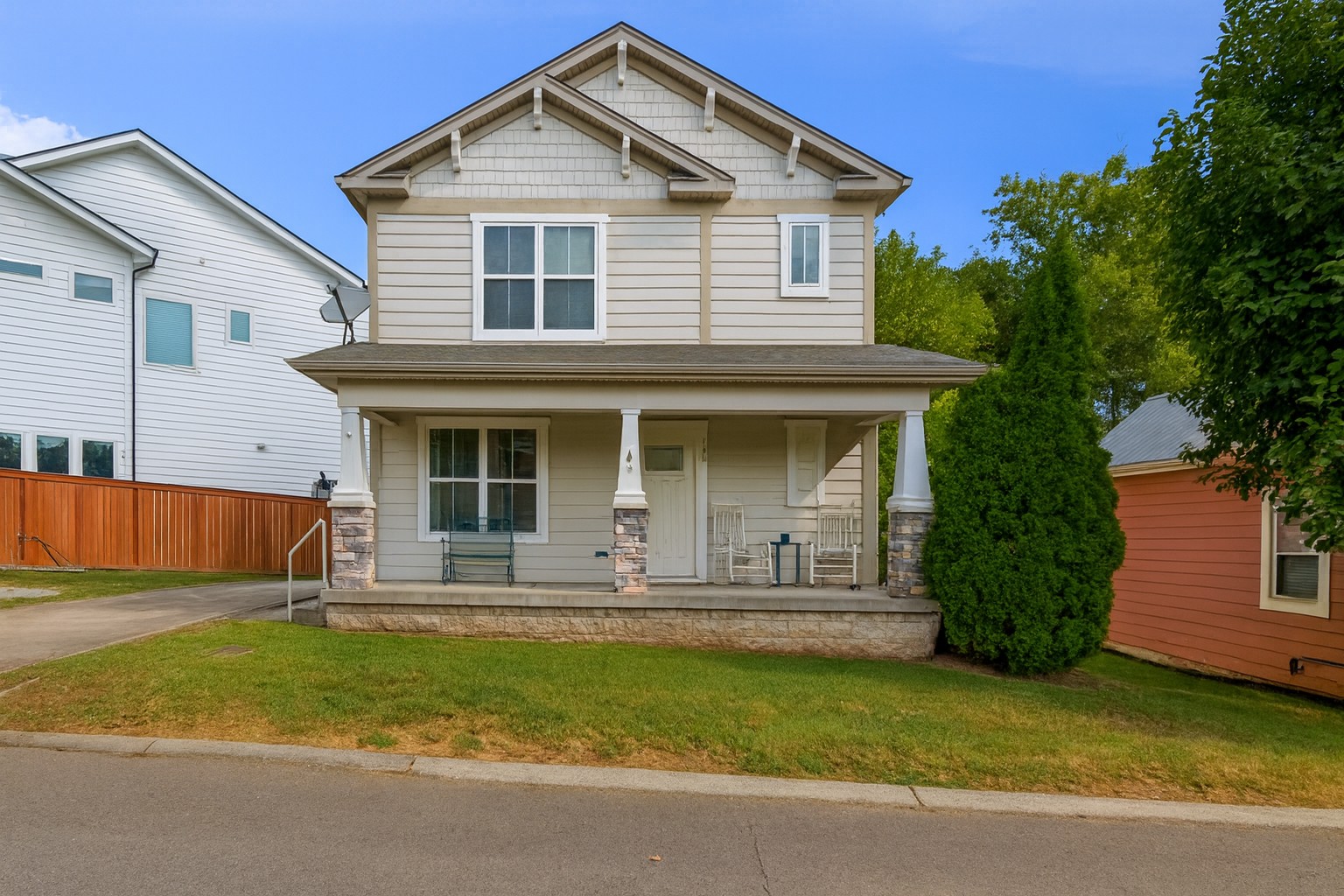 a front view of a house with a garden and porch